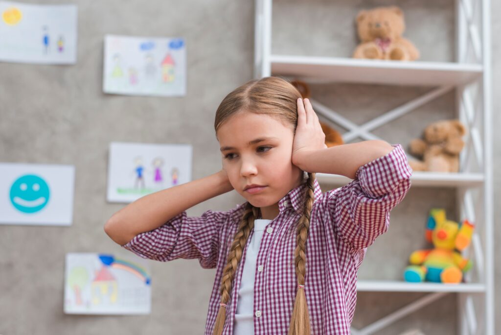 portrait sad girl covering her ears with two hands 1